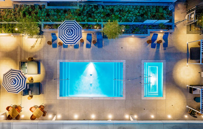 Pet-Friendly Apartments in South Park Los Angeles, CA - The Emerald - Aerial View of Pool, with Blue Lounge Chairs and Cabanas