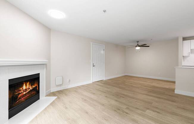 A room with a fireplace and a ceiling fan.