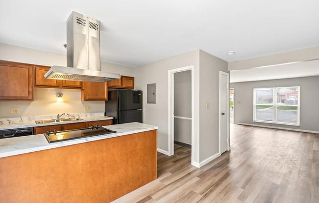 A modern kitchen with wooden cabinets and a large island.