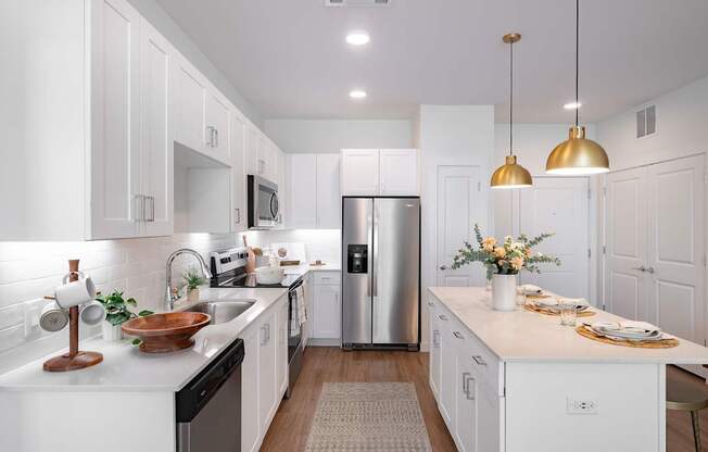 a kitchen with white cabinets and stainless steel appliances