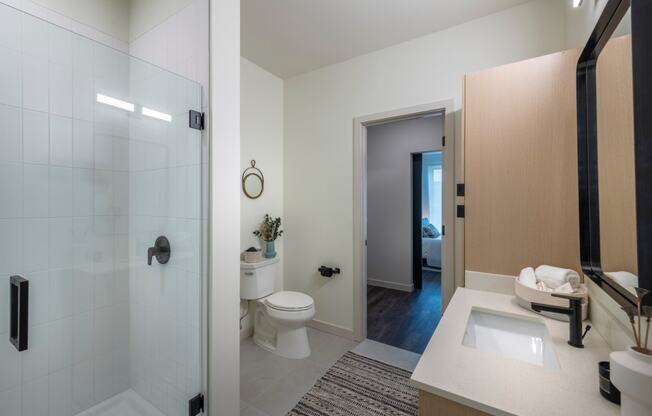 a bathroom with a shower toilet and sink