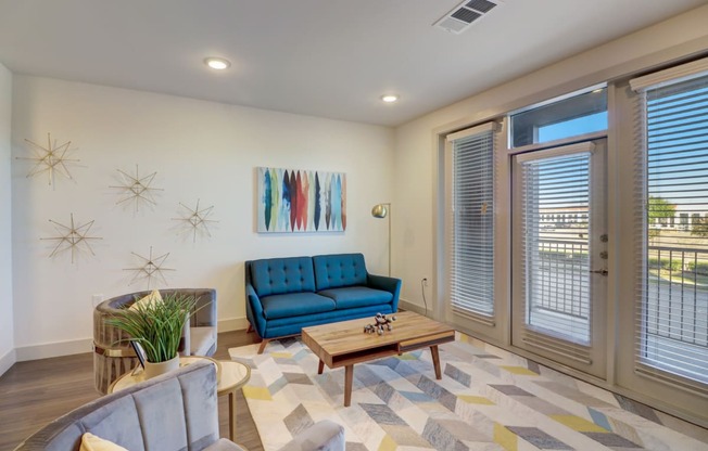 a living room with a blue couch and a coffee table