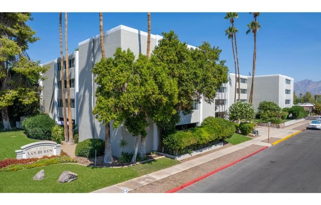 A street view of a residential area with a sign that reads "Van Buren".