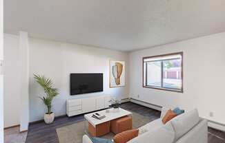 a living room with a white couch and a tv. Fargo, ND Rosegate Apartments