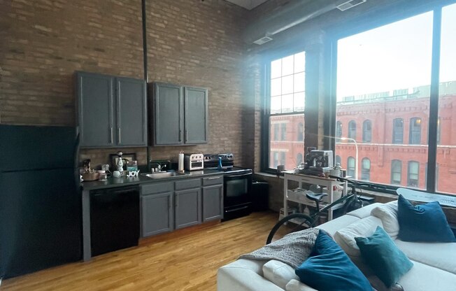 an open living room and kitchen in a loft apartment