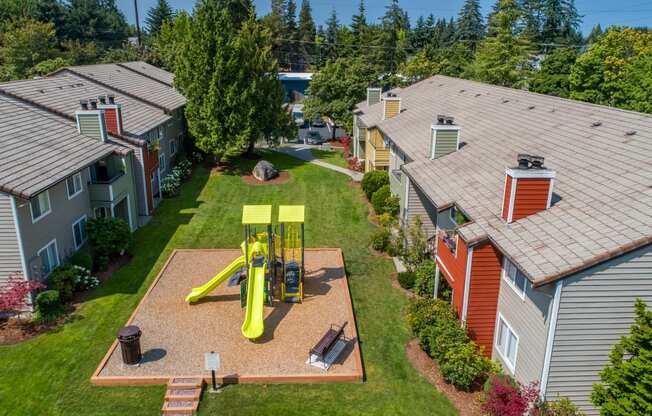 an aerial view of a yellow swing set in the backyard of a house at Quartz Creek, Washington