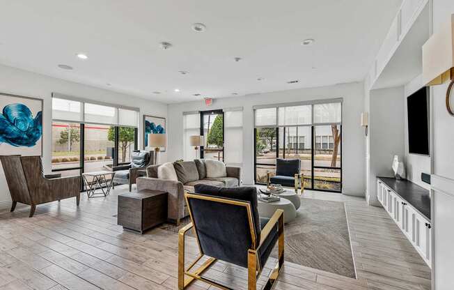 A living room with a black chair and a wooden table.