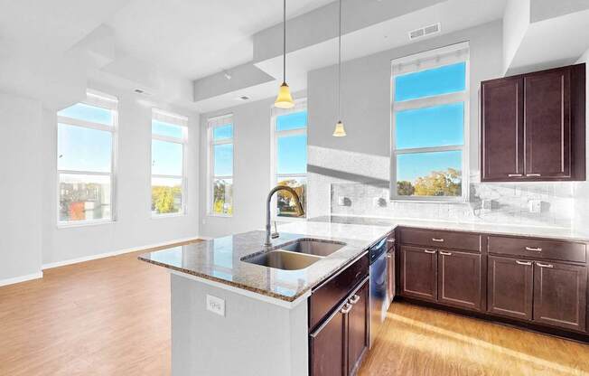 A kitchen with a large island and wooden cabinets.