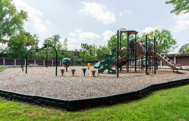 a playground with a climbing structure and picnic tables