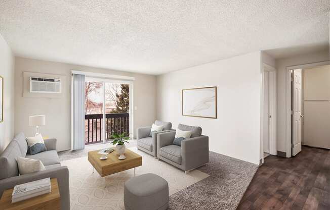 A living room with a couch, coffee table, 2 chairs, and a door leading to a private balcony.at Wildflower, Washington, 99336