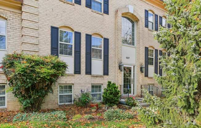 A building with black shutters and a white door.