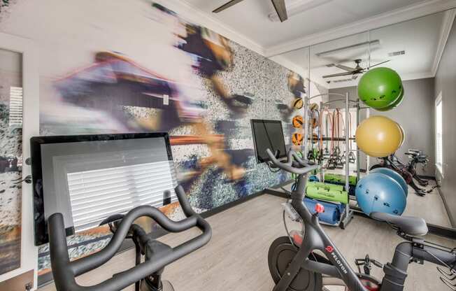 a home gym with exercise bikes and a computer at Carrington at Barker Cypress, Cypress, 77433