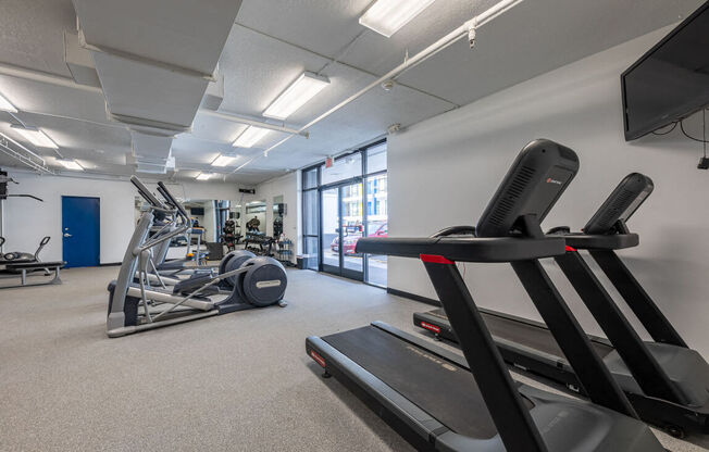 the gym at the flats at obsidiancontinued furnished area with exercise equipment