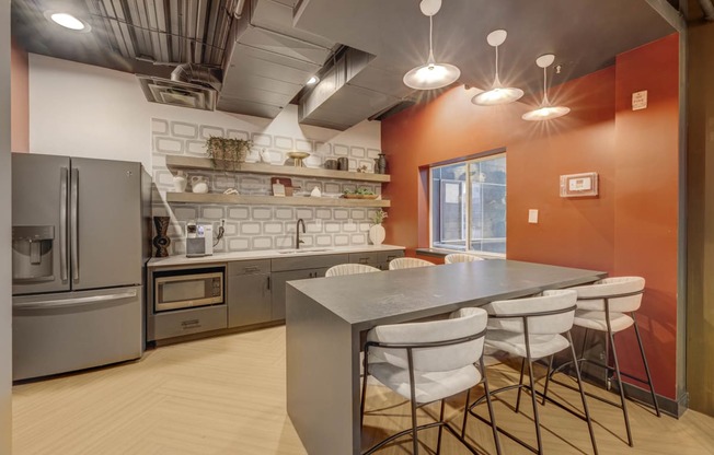 a kitchen with a table and chairs and a refrigerator