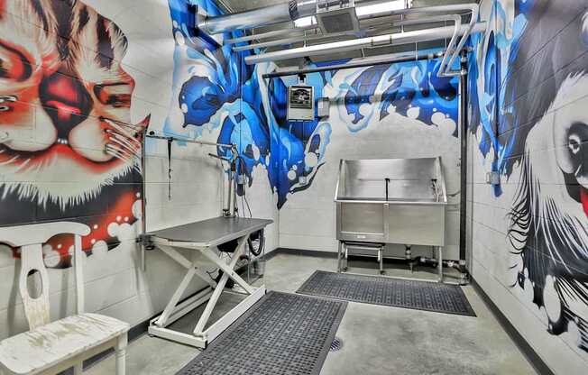 A room with a mural of a tiger on the wall and a table in the middle.