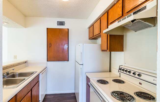 Unit Kitchen with White Appliances at Heritage Square Apartments in Waco, TX