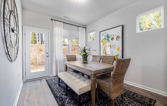 a dining room with a table and chairs and a door