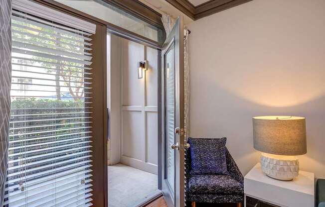 A room with a chair and a lamp.