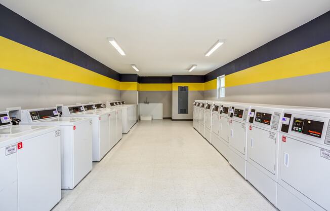 a laundry room filled with washes and dryers at The Hub at Baton Rouge, Baton Rouge, 70808