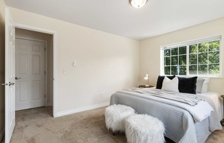 a bedroom with a bed and a white door