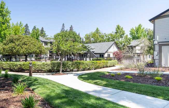 A residential area with houses and well-maintained lawns.