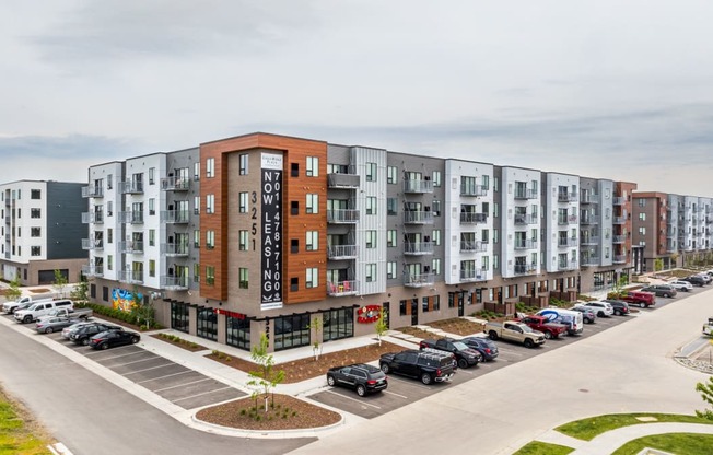 a large apartment building with cars parked in front of it at EagleRidge Plaza Residences, Fargo, ND, 58104