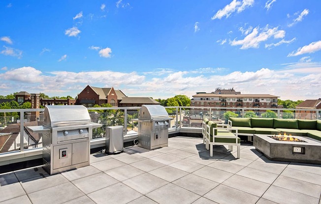 Studios in Mount Prospect, IL - 20 West - Outdoor Patio with Green Cushioned Seating Next to a Grilling Area