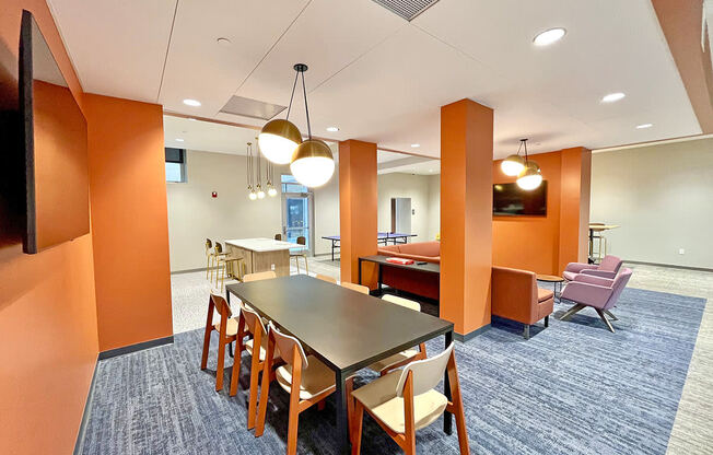 clubroom/resident lounge with large work table at The Residences at Delmar DivINe, St Louis