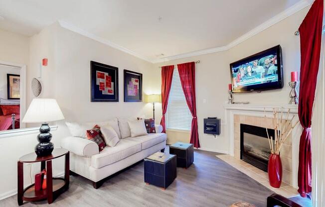 a living room with a white couch and a television