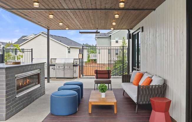 A patio with a fireplace and seating area.