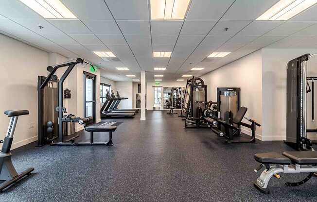 A spacious gym with various exercise equipment.