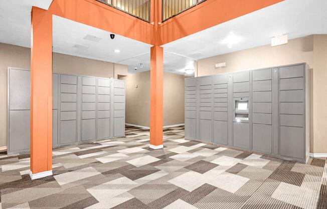 a row of lockers in a room with orange pillars