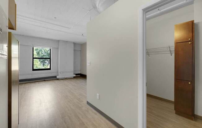 A room with a wooden floor and a window.