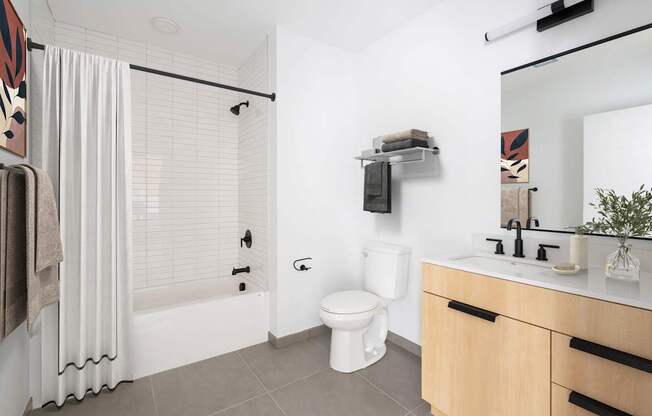 A white toilet sits next to a sink in a bathroom.