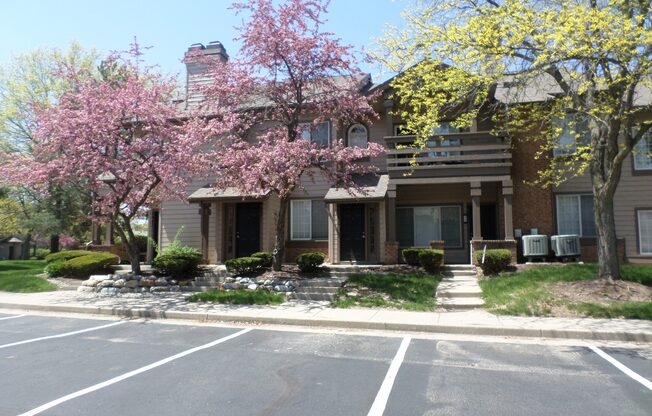 A building with a tree in front of it.