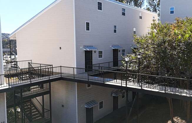 the exterior of a building with a balcony and stairs