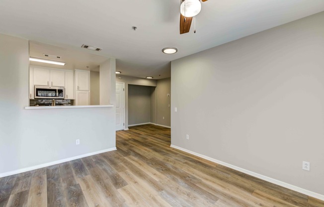 living room with vinyl wood flooring and ceiling fan at at Cypress Villas Apartments