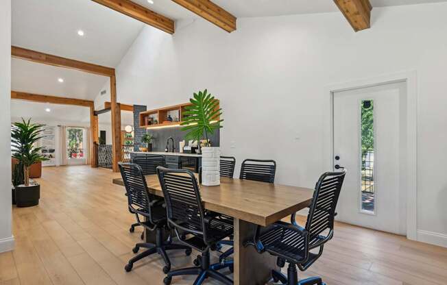 A conference room with a long table and chairs.