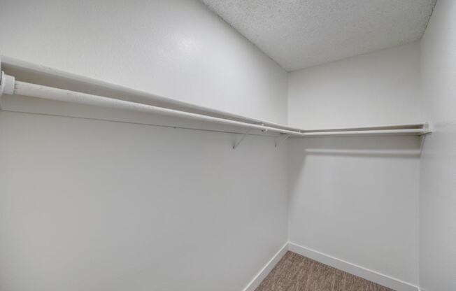 the interior of an empty room with white walls and a white closet