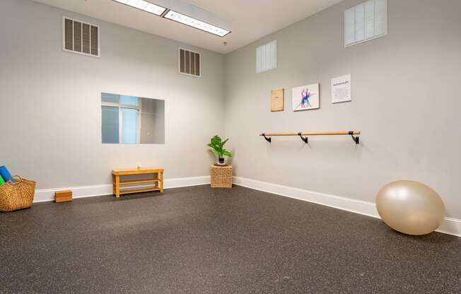 an empty room with a yoga ball and a table