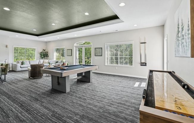 A room with a pool table and a other games