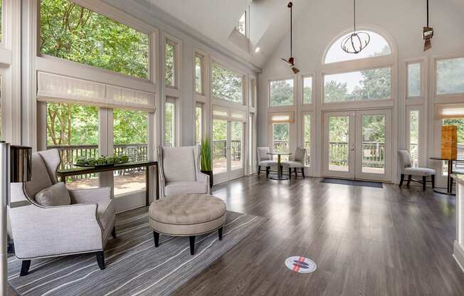 a living room with a large amount of windows and furniture