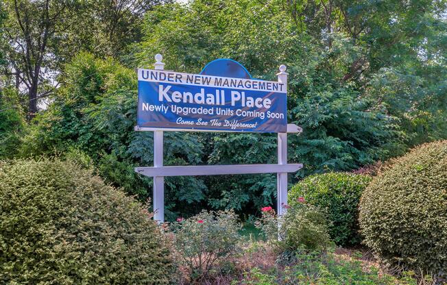 a street sign in front of bushes