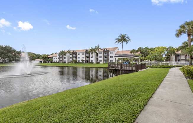 the park at the waters edge of a lake with a fountain