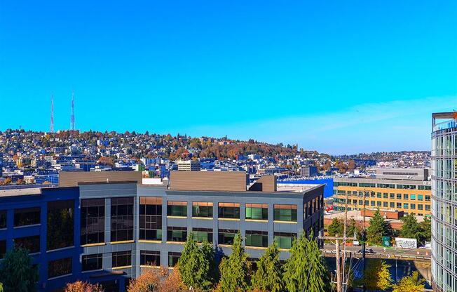 an aerial view of a building with a city in the background