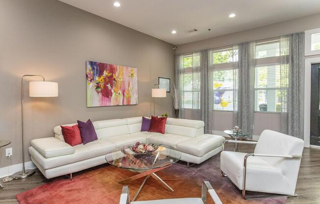 a living room filled with furniture and a large window