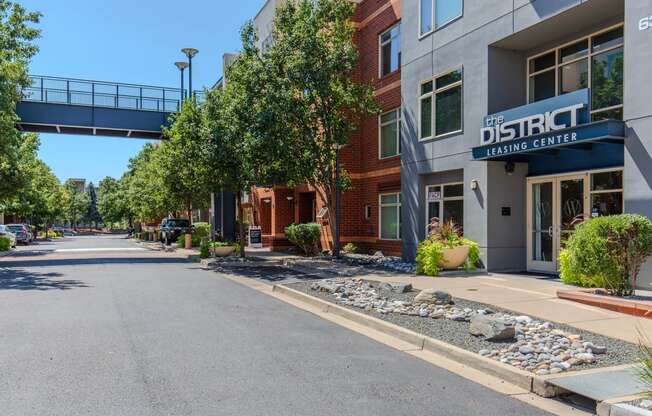 a street view of a building with a bridge over the street