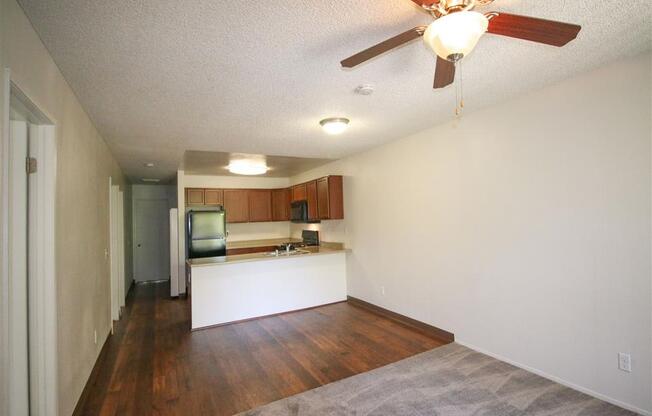 Living Room With Kitchen View at Creekside Villas Apartments, San Diego