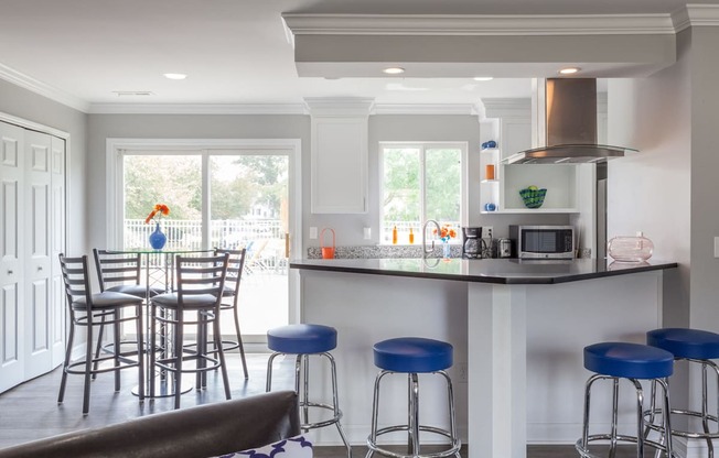 A kitchen with a bar area and a dining table.