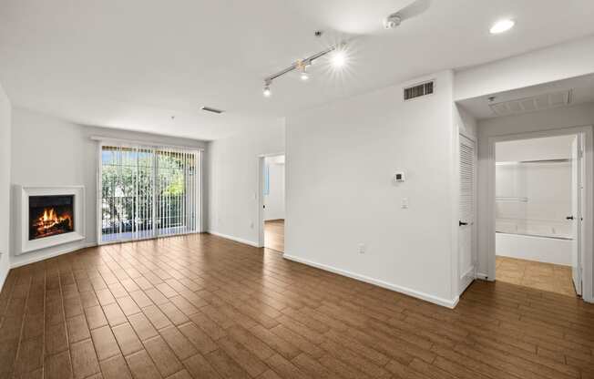 a living room with a fireplace and a wooden floor